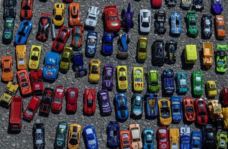 Colorful collection of diecast model cars arranged on asphalt